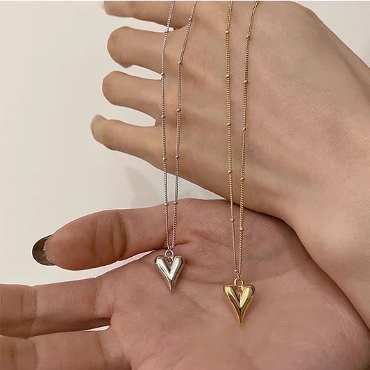 925 sterling silver and 18K gold plated heart necklaces side by side
